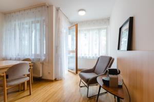 a living room with two chairs and a table at Studiowohnungen am Rieger-Hof in Hartmannsdorf +13 photos