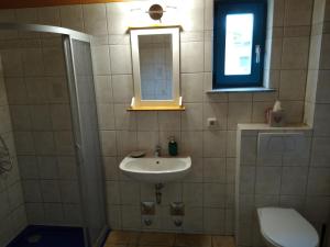 y baño con lavabo, espejo y aseo. en Maisonettewohnung auf 2 Etagen mit zwei Balkonen en Barth