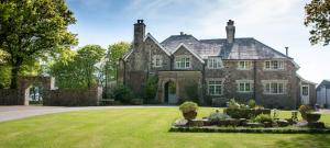 an old stone house with a large yard at Knole Farm in Okehampton