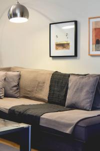 a couch with a blanket on it in a living room at Two bedroom apartment in Kesariani in Athens
