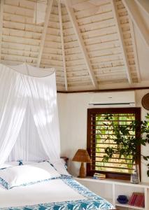 a bedroom with a bed and a window at GoldenEye in Oracabessa