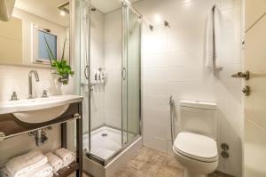a bathroom with a toilet, sink, and shower at Up Recoleta Hotel in Buenos Aires