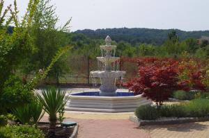 a large fountain in the middle of a garden at Lily Beach Resort in Sozopol