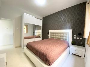 a bedroom with a large bed and a mirror at Sea Suites in Tel Aviv