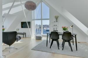 - une salle à manger avec une table et des chaises dans l'établissement Harbour Penthouse, à Sønderborg
