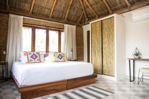 a bedroom with a large white bed and windows at PAL.MAR Hotel Tropical in San Francisco