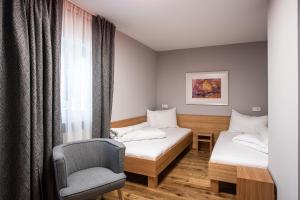 una habitación de hospital con 2 camas y una silla en Villa 10 en Oetz