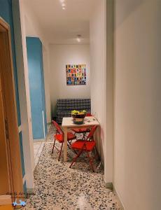 a dining room with a table and a chair at Ale&Andrea Apartments in Rome