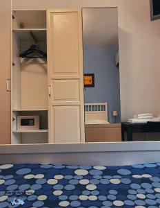 a room with a mirror and a blue and white floor at Ale&Andrea Apartments in Rome