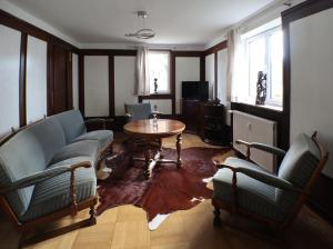 a living room with couches and a table and chairs at Ferienwohnung Weiß in Hilchenbach