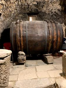 a large wooden barrel sitting in a stone cave at Hotel Casa Fumanal in Abizanda