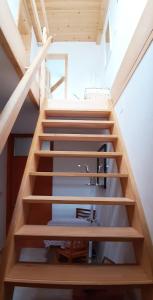 a staircase with wooden risers in a house at Prenočišča Angelin hram, Tiny Apartments in Markovec