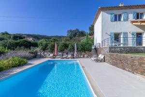 a swimming pool in front of a house at La Gaoute in Sainte-Maxime