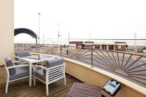 a balcony with a table and chairs on a roof at Queens Mansions: Duchess Suite in Blackpool