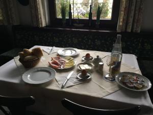 uma mesa com uma toalha de mesa branca com comida em Gästehaus Fäßle em Weinstadt