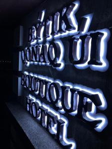 a neon sign that reads littleolinainois institution hospital at BOUTIQUE HOTEL 1967 AQSAI in Aksay