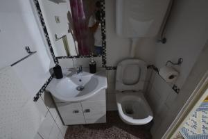 a small bathroom with a sink and a toilet at Casa Murroni in Pau +33 photos