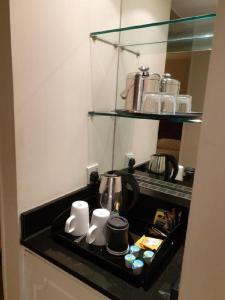 a bathroom with a sink and a shelf full of toothbrushes at Grand Hotel Sunderland in Sunderland