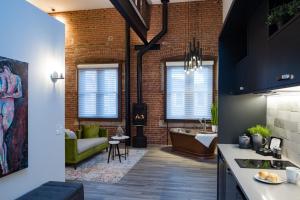a kitchen and living room with a brick wall at 48 King West Boutique Hotel in Brockville