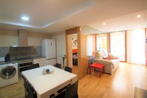 a kitchen and living room with a table and a couch at Modern CasaTuris Apartment with Castle Views A131 in Alicante