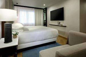 A television and/or entertainment centre at Hyatt Regency Hesperia Madrid