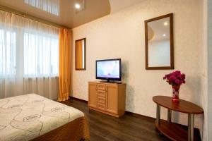 a hotel room with a bed and a television at Apartment on Staroobriadnytska 3 in Kherson