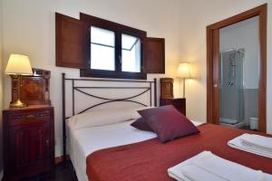 Postel nebo postele na pokoji v ubytování Le Luci su Ibla - Ospitalità con vista