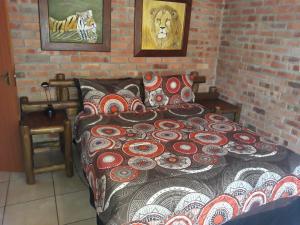 a bedroom with a bed with a patterned comforter at Eagle's Crest in Marloth Park +35 photos