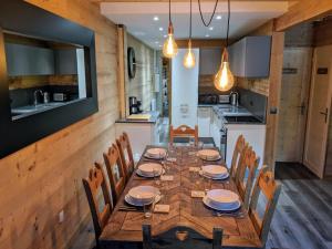 a dining room with a wooden table and chairs at Chalet Neve in Les Deux Alpes