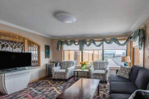 a living room with a couch and a tv at Quality Inn & Suites University Area in Muncie