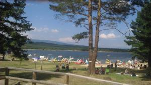 a group of people on a field near a lake at Los Trashumantes in Molinos de Duero