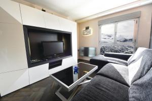 un soggiorno con divano e TV a schermo piatto di El Semáforo - Lujo, Confort y Vistas Espectaculares a Sierra Nevada