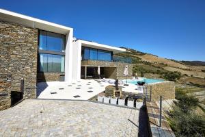 a large stone house with a swimming pool at Quinta Rainha Santa Mafalda in Pinhão