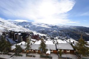 una città coperta di neve con le montagne sullo sfondo di El Semáforo - Lujo, Confort y Vistas Espectaculares a Sierra Nevada