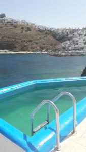 a swimming pool with a view of the ocean at Caldera Studios in Astypalaia