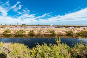 a body of water with a blue sky and clouds at Apartamentos Mar y Sal in La Savina