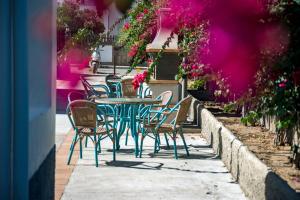 a table and chairs with flowers on a patio at Apartamentos Mar y Sal in La Savina
