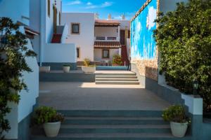 a hallway of a building with stairs and plants at Apartamentos Mar y Sal in La Savina