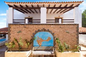 a brick wall with a mural of a camel on it at Apartamentos Mar y Sal in La Savina