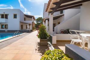 a view of the courtyard of a house with a swimming pool at Apartamentos Mar y Sal in La Savina