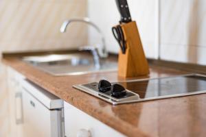 a kitchen counter top with a sink and a sink at Apartamentos Mar y Sal in La Savina