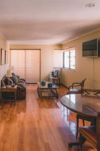 a living room filled with furniture and a flat screen tv at Alessandria Apart - Coronel Pereira in Santiago +15 photos