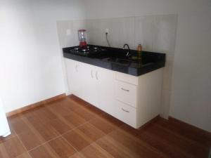 a kitchen with a sink and a counter top at KITNET'S DA DENI in Alto Paraíso de Goiás +13 photos