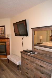 - une chambre avec un lit et une commode avec une télévision dans l'établissement River Place Condos #509 1BD, 2 Bath, à Pigeon Forge