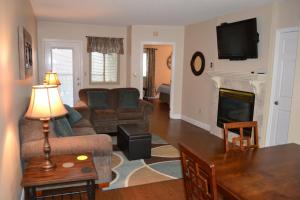 a living room with a couch and a fireplace at River Place Condos #504 2BD in Pigeon Forge