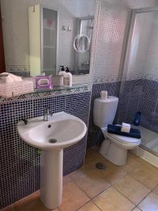 a bathroom with a sink and a toilet at Casa Achille in Cotillo