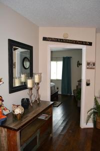 a living room with a table and a mirror at River Place Condos #206 2BD in Pigeon Forge