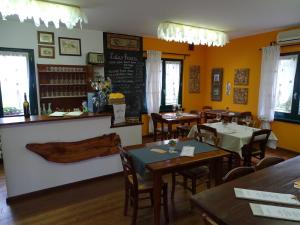 a restaurant with tables, chairs, and tables in it at Agriturismo Le oche selvatiche in Lauzacco