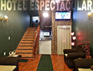 a lobby with a staircase and a tv in a room at Hotel Espectacular in Callampaya