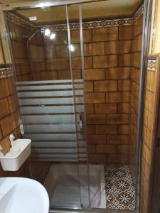 a shower with a glass door in a bathroom at El Nido in Zahara de la Sierra